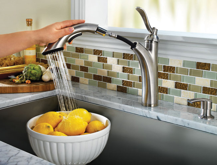 The faucet features a high arcing spout with a pull out spray wand.
