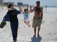Mommy and Daddy swinging Charlie at Clearwater Beach March 2009