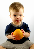 NAMC montessori classroom infant toddler circle time activities boy with orange