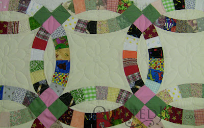 Scrappy Double Wedding Right quilt on the APQS Millie Frame - QuiltedJoy.com