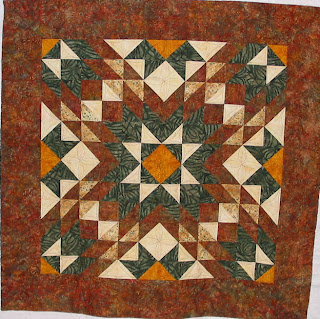 Debbie's Batik Star with custom quilting by Angela Huffman - QuiltedJoy.com