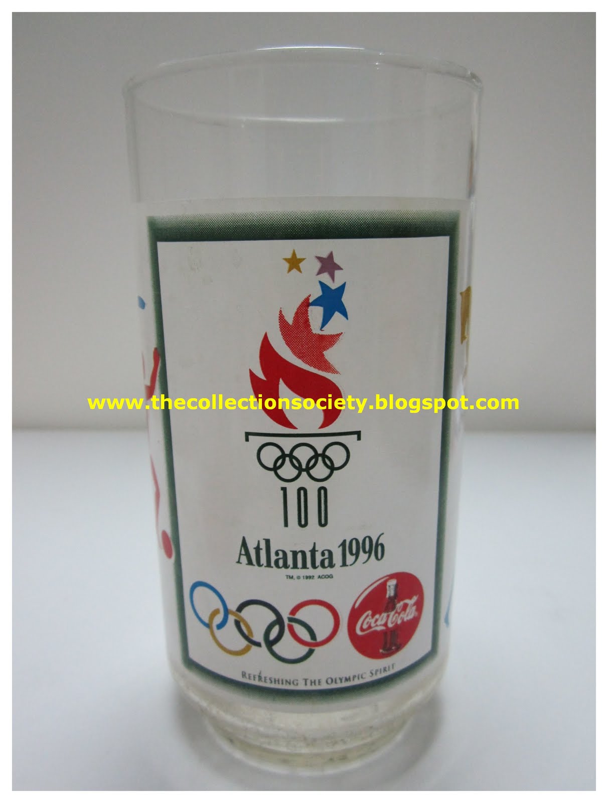 TCS GROUP THE COLLECTION SOCIETY Coca Cola Atlanta 1996 glass white TCS GROUP THE COLLECTION SOCIETY Coca Cola Atlanta 1996 glass white