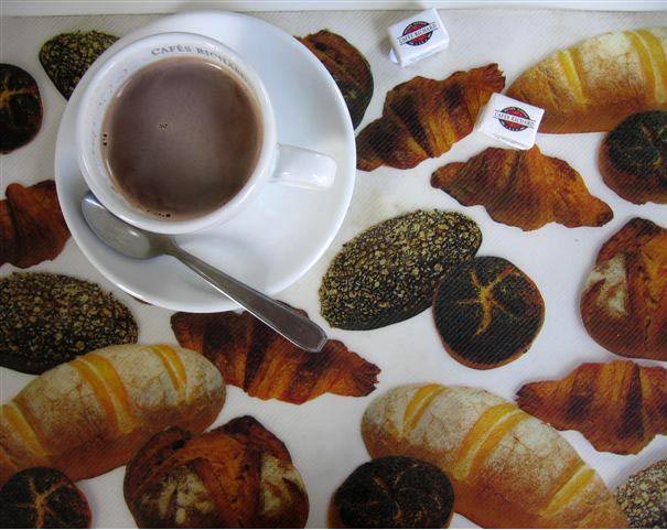 Overhead view of cup of coffeE on a place mat