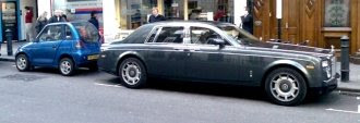 Rolls-Royce Phantom parked next to a GoinGreen G-Wiz