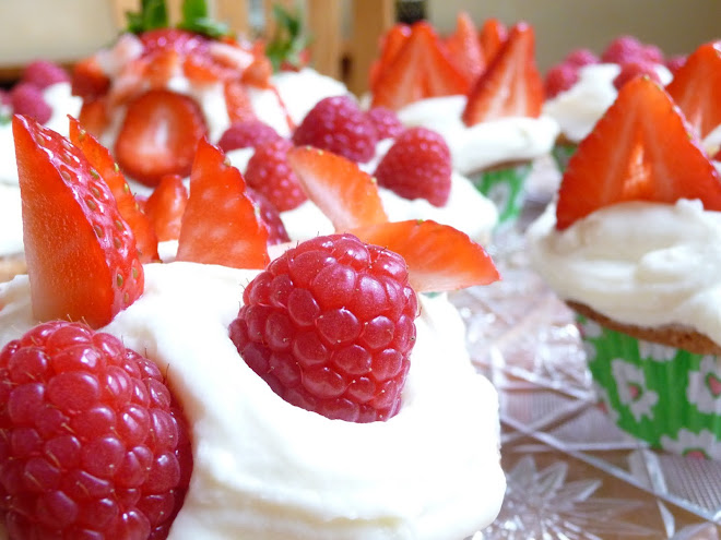Fresh Strawberry Slices & Whole Raspberries tucked into cream cheese frosted vanilla cupcakes