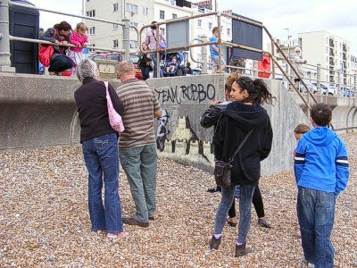 A crowd looking at the Banksy