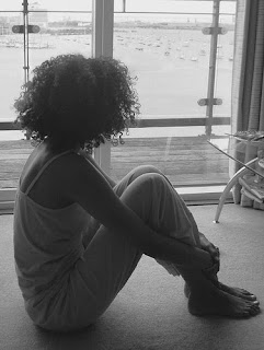 African American adolescent girl in contemplation and partial silhouette