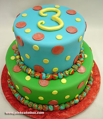 three tiered multi-colored third birthday cake
