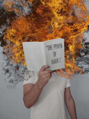 child holding up book entitled the power of books, with flames coming out of it.