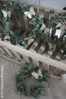 Some branches of eucalyptus are twisted around graying wreaths