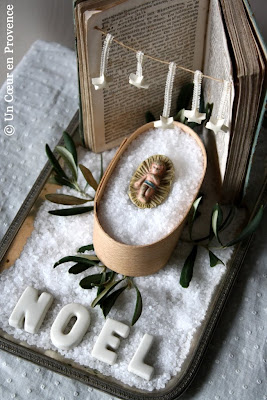 a crib made with an antique book which is hung with a few small stars