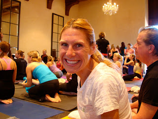 Woman smiling on yoga mat at Master Class