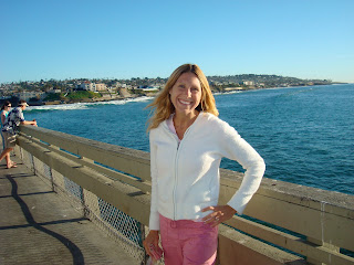 Woman standing on pier in front of ocean