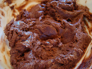 Chocolate and peanut butter stirred with agave and vanilla in bowl