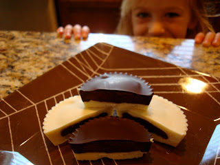 Peanut Butter Cups on plate with young girl peaking over counter
