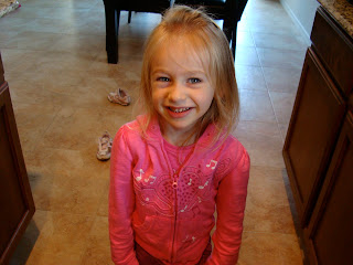 Young girl in pink smiling