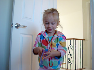 Young girl playing with book wearing beads