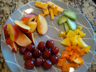Plate full of mixed vegetables and fruit with cheese