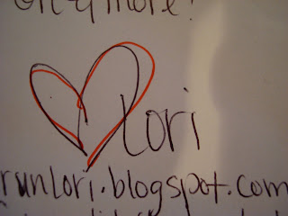 Drawing on white board with heart symbol and the name Lori