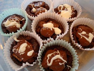 Close up of Brownie Cupcakes with Mint Chocolate Frosting with White Chocolate Drizzle in containers
