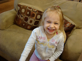 Smiling young girl on oversized chair