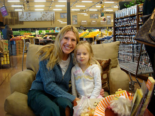 Woman and child sitting in overside chair in grocery store