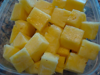 Diced up pineapple in clear container 