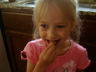 Young girl eating cinnamon sugar covered pretzels