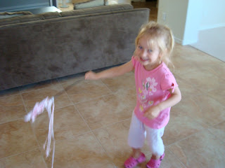 Young girl in pink dancing with princess wand