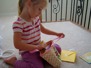 Young girl looking in smaller easter basket