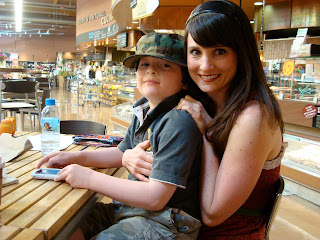 Woman smiling with young boy on lap