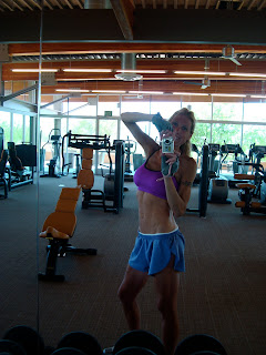 Woman taking photo of self at gym