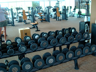 Gym showing rows of dumbbells 