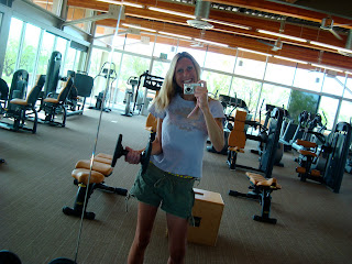 Woman lifting dumbbells in mirror