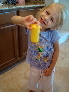 Young girl holding a piece of corn