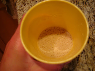 Protein powder and water in yellow cup