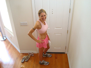 Woman in front of door in running attire 