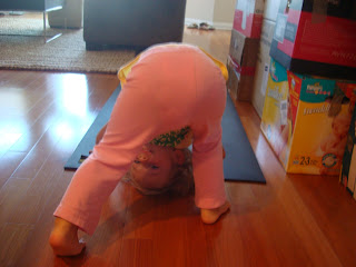 Little girl doing adho mukha savasan yoga pose