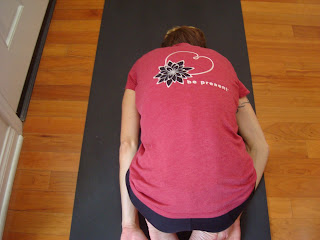 Woman on yoga mat doing yoga pose
