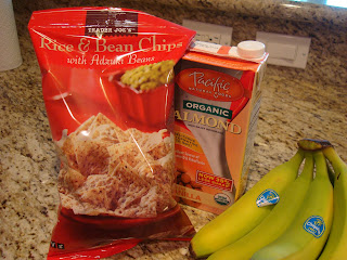 Bag of rice and bean chips, container of almond milk and bananas