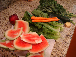 Watermelon rind with vegetables and greens on countertop