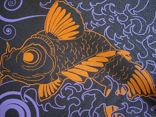 Orange fish on yoga mat surrounded by purple designs