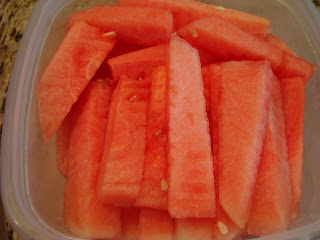 Sliced up watermelon in clear container