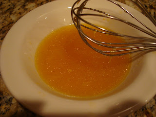 Homemade dressing being whisked in white bowl
