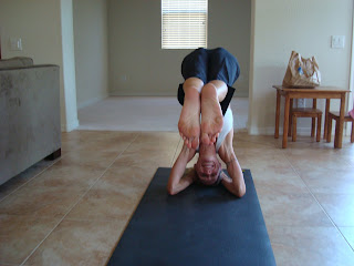 Woman doing half headstand yoga pose