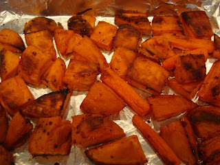 Roasted sweet potatoes and carrots in baking pan