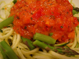 Close up of Zucchini Noodles topped with asparagus spears and marinara sauce