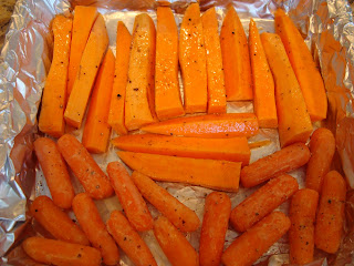 Glazed sliced sweet potatoes and baby carrots in foil lined pan