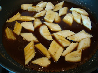 Sliced bananas in pan with melted brown sugar mixture 
