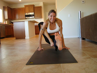 Woman doing loating version of Maricyasana A yoga pose
